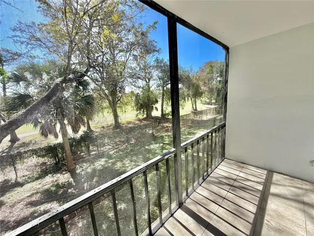 a view of a balcony with wooden floor