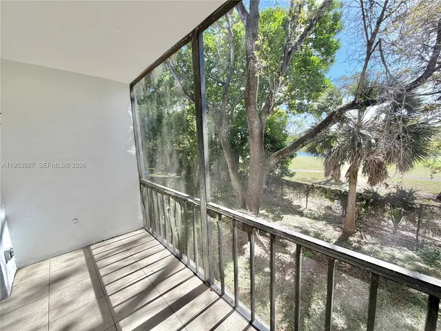 a view of balcony with wooden floor and fence