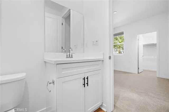 a bathroom with a sink toilet and vanity