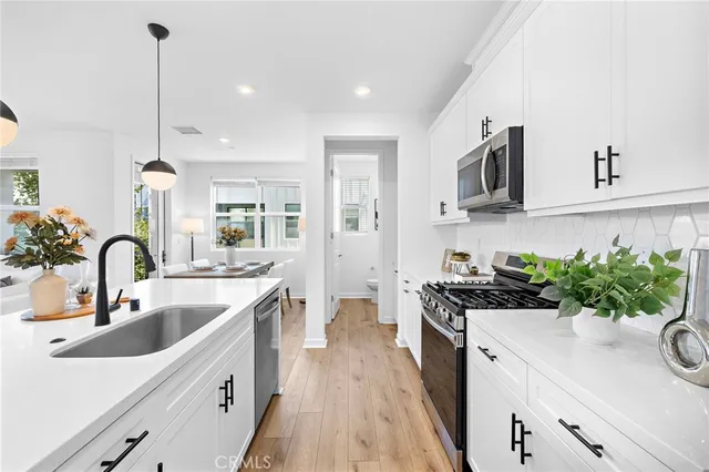 a kitchen with a sink stove top oven and microwave