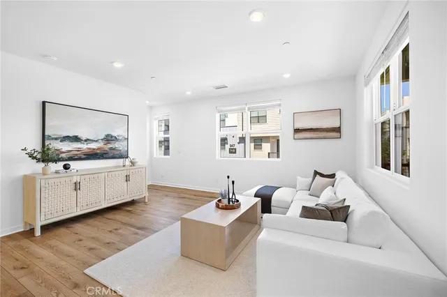 a living room with furniture and wooden floor