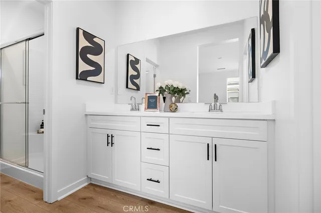 a bathroom with a sink vanity and a mirror