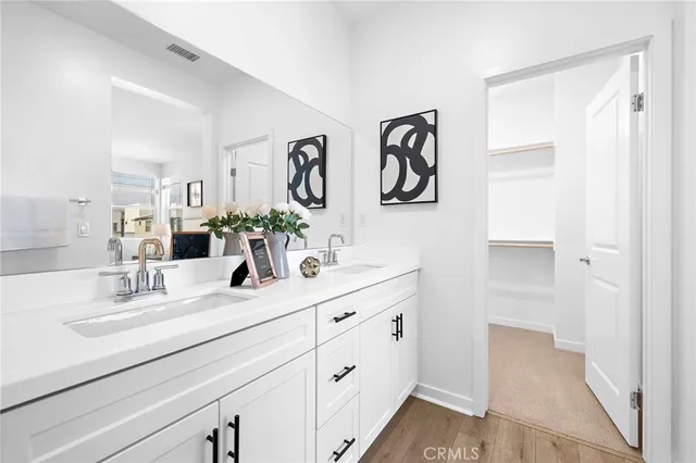 a bathroom with a double vanity sink and a mirror