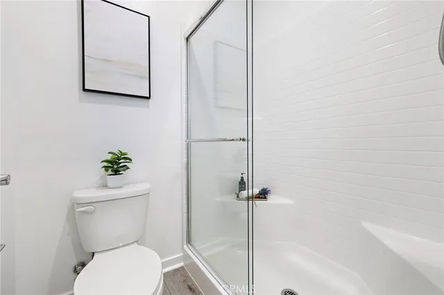 a white toilet sitting next to a bath tub