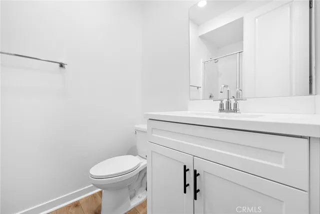a bathroom with a sink vanity mirror and toilet