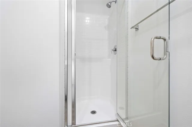 a bathroom with a glass shower door