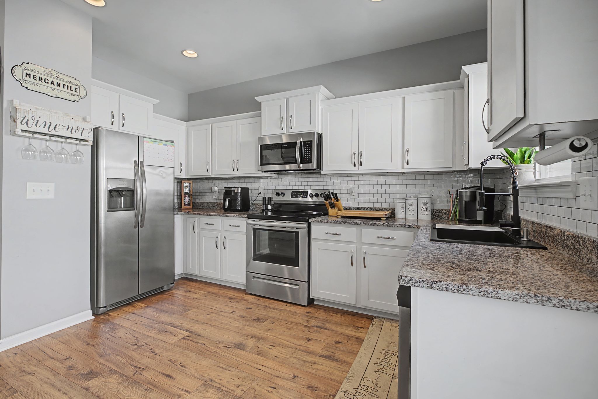 202 Bell Forge Court White Bluff, TN 37187 - Photo 9 of 16 a kitchen with granite countertop a refrigerator sink and white cabinets