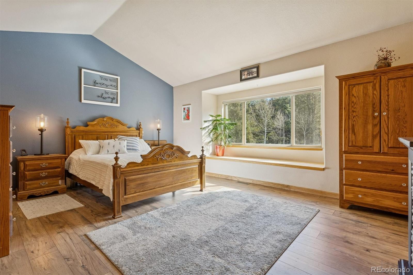 2230 County Road 72 Bailey, CO 80421 - Photo 19 of 50 a spacious bedroom with a bed and wooden floor