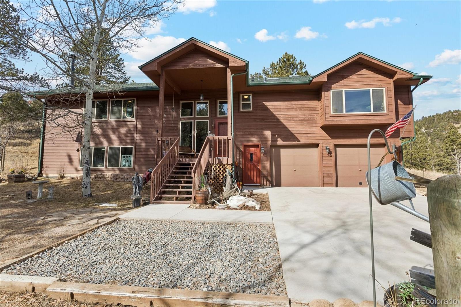 2230 County Road 72 Bailey, CO 80421 - Photo 2 of 50 a front view of a house with glass windows