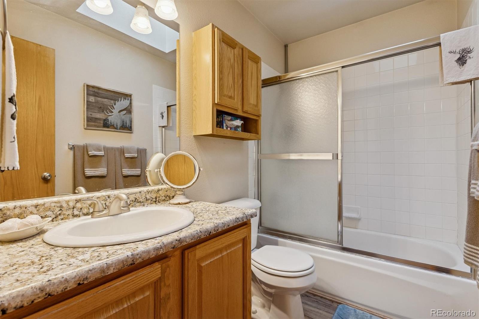 2230 County Road 72 Bailey, CO 80421 - Photo 22 of 50 a bathroom with a granite countertop sink toilet and a mirror