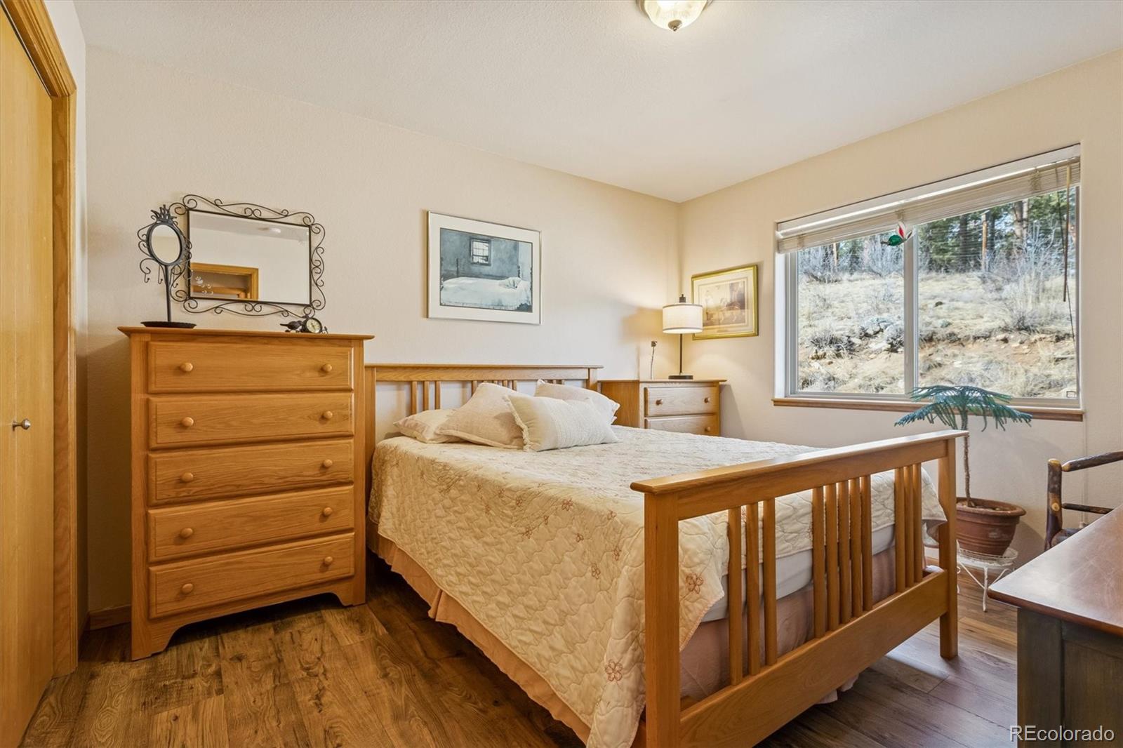 2230 County Road 72 Bailey, CO 80421 - Photo 23 of 50 a bedroom with a bed and wooden floor