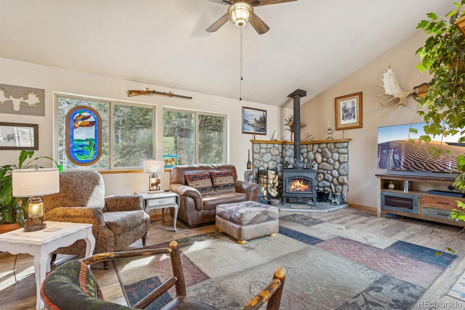 2230 County Road 72 Bailey, CO 80421 - Photo 5 of 50 a living room with fireplace furniture and a window