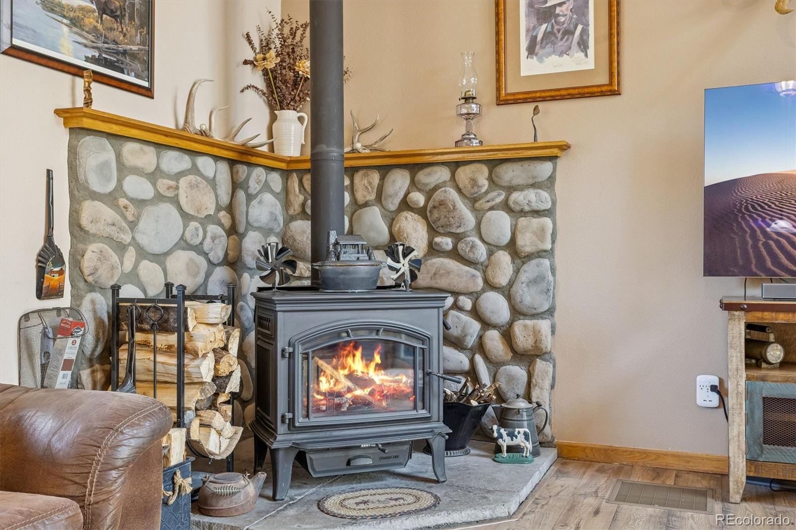 2230 County Road 72 Bailey, CO 80421 - Photo 6 of 50 a living room with fireplace furniture and a flat screen tv