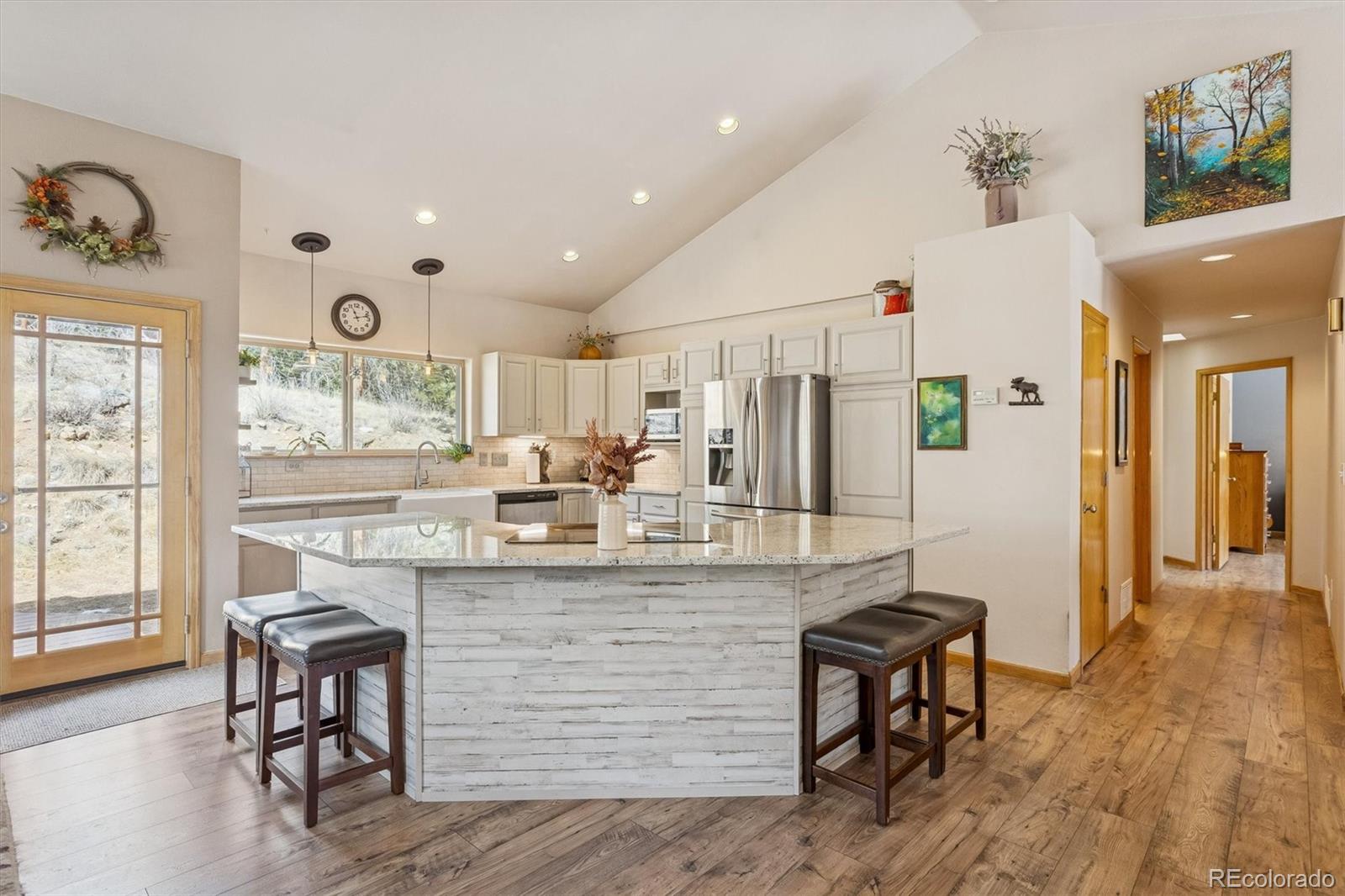 2230 County Road 72 Bailey, CO 80421 - Photo 10 of 50 a kitchen with kitchen island stainless steel appliances a table and chairs in it
