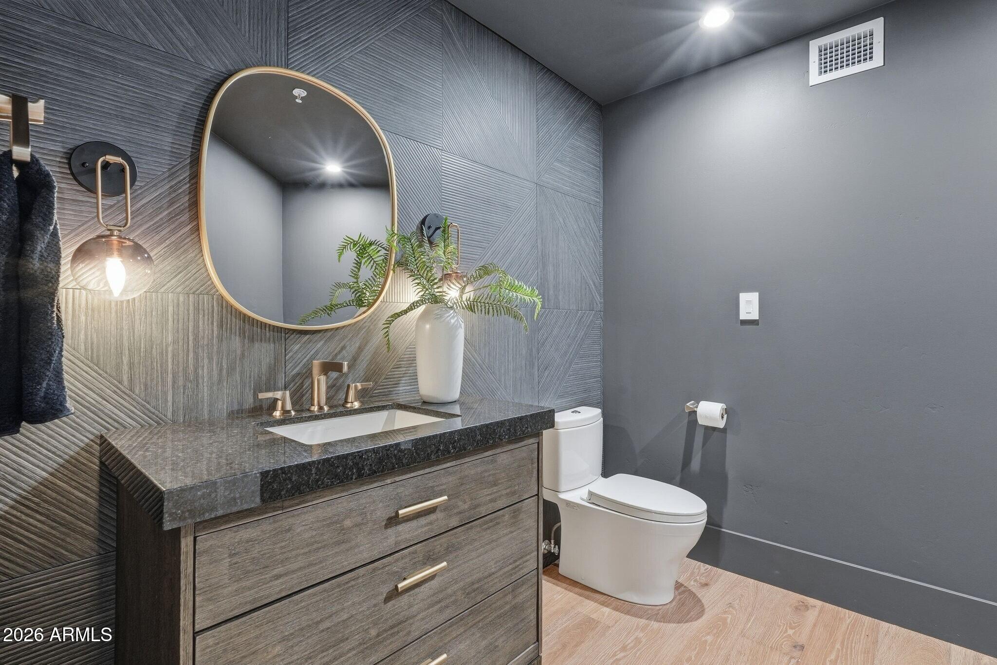 7475 East Gainey Ranch Road, Unit 7 Scottsdale, AZ 85258 - Photo 55 of 77 a bathroom with a toilet sink and mirror
