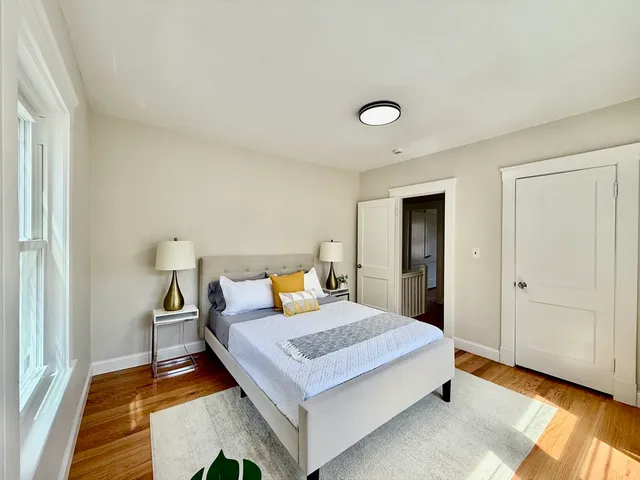 a bedroom with a bed and a night stand