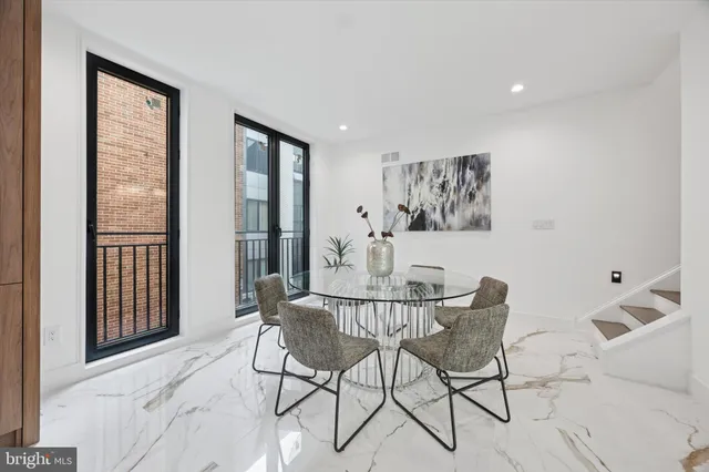 a dining room with furniture and wooden floor