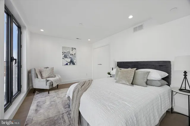 a bedroom with a bed window and a couch