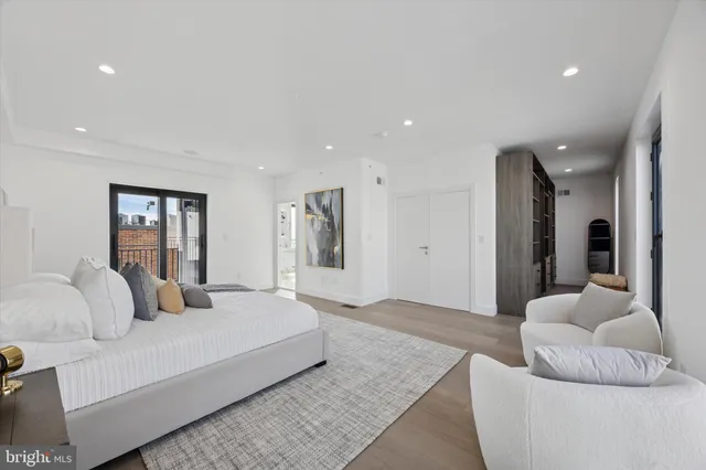 a bedroom with a large bed and a painting