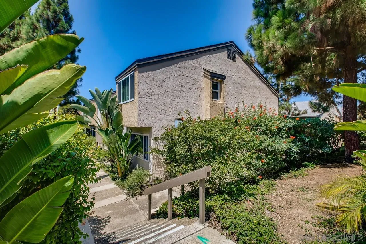 8524 Via Mallorca, Unit E La Jolla, CA 92037 - Photo 2 of 14 a front view of house with yard and green space