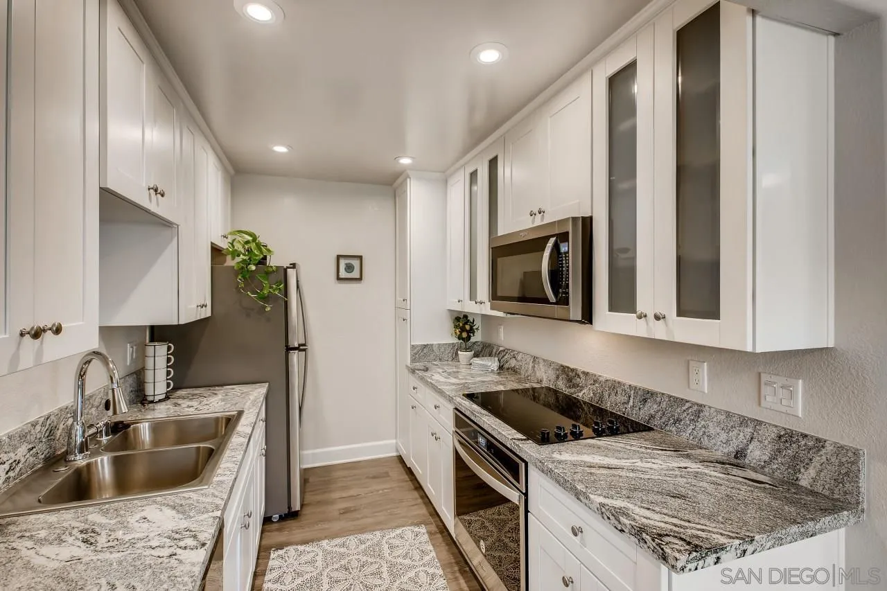 8524 Via Mallorca, Unit E La Jolla, CA 92037 - Photo 5 of 14 a kitchen with a stove and a sink