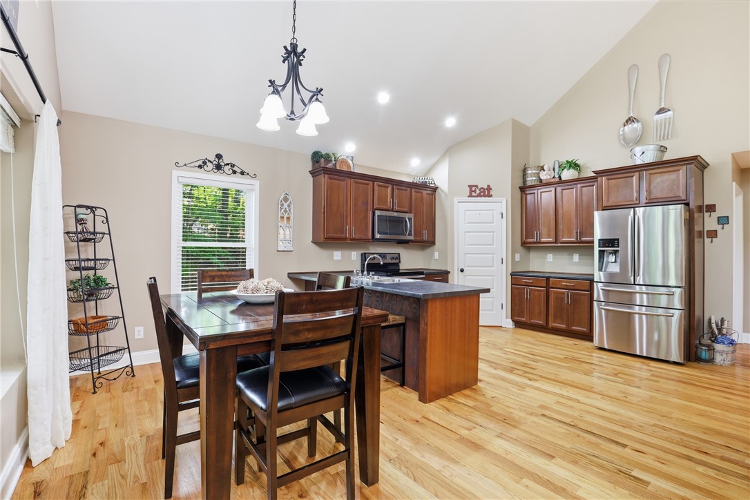 1110 Sunset Lane Anderson, SC 29626 - Photo 8 of 38 A well-lit kitchen with soaring vaulted ceilings, warm hardwood floors, and abundant cabinetry.
