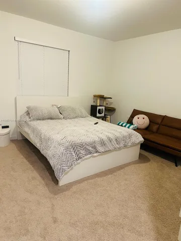 a bedroom with a bed and with furniture