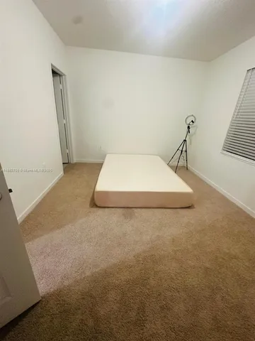 a room with a bed and a window