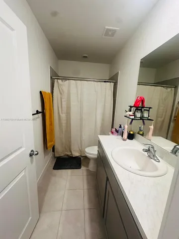 a bathroom with a sink a toilet and a shower
