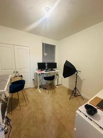 a living room with furniture and a piano
