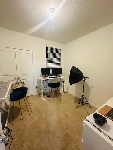 a living room with furniture and a piano