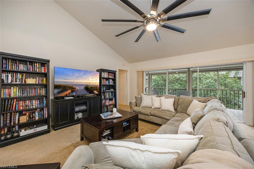 164 Via Perignon, Unit 84 Naples, FL 34119 - Photo 11 of 34 a living room with furniture a bookshelf and a window