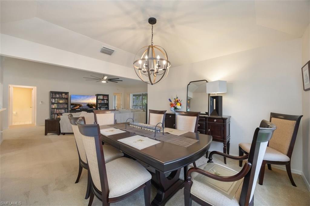 164 Via Perignon, Unit 84 Naples, FL 34119 - Photo 17 of 34 a view of a dining room with furniture a chandelier and a window