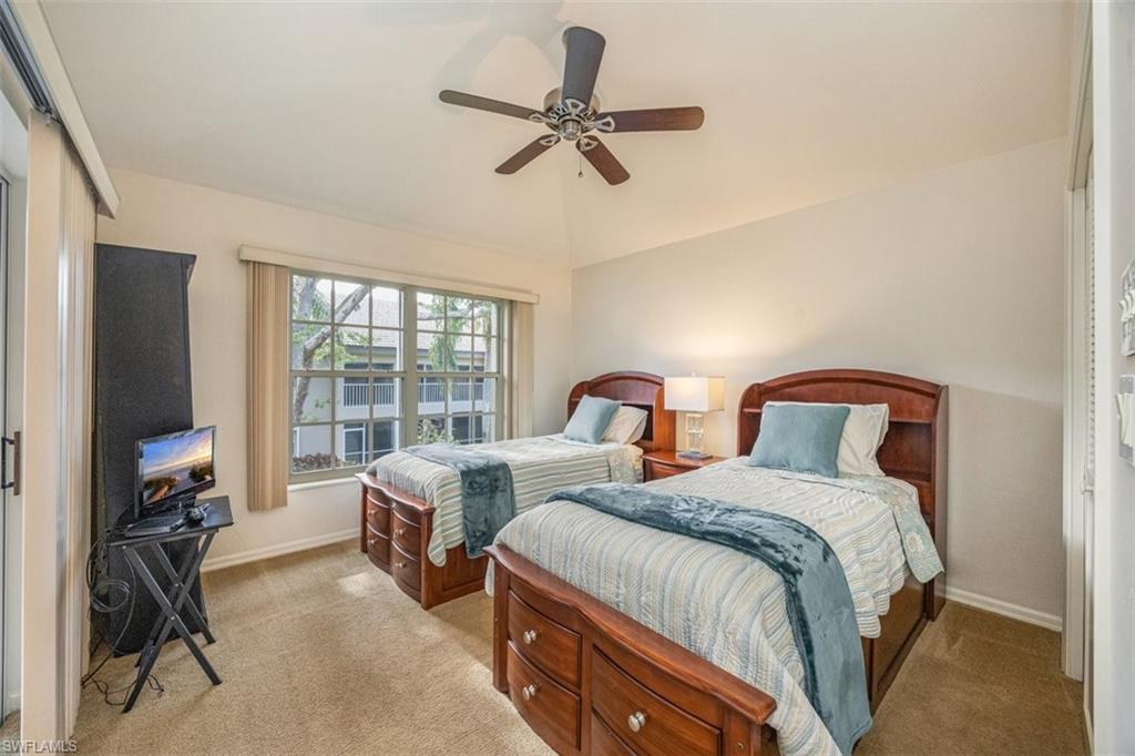164 Via Perignon, Unit 84 Naples, FL 34119 - Photo 21 of 34 a bedroom with two beds and a desk