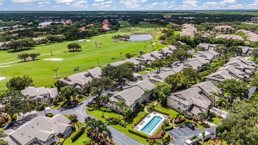 164 Via Perignon, Unit 84 Naples, FL 34119 - Photo 26 of 34 an aerial view of a houses with a yard
