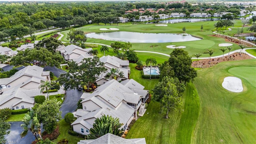 164 Via Perignon, Unit 84 Naples, FL 34119 - Photo 29 of 34 an aerial view of a house with a garden and lake view