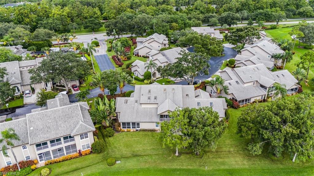 164 Via Perignon, Unit 84 Naples, FL 34119 - Photo 30 of 34 an aerial view of multiple houses with yard