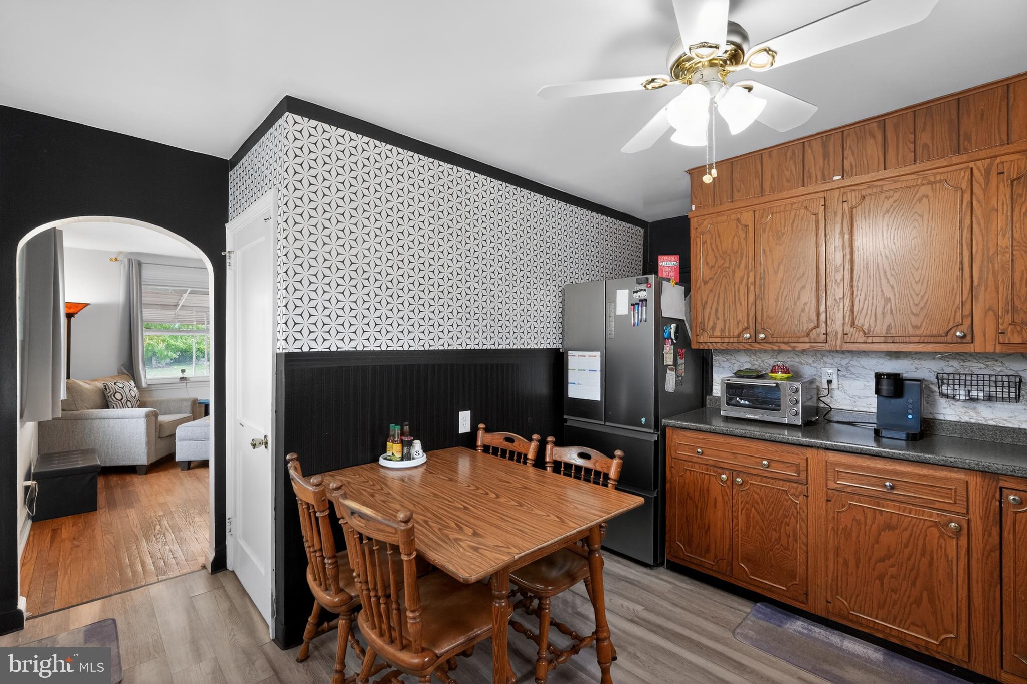 518 Bonsall Road Ridley Park, PA 19078 - Photo 8 of 31 a open kitchen with stainless steel appliances granite countertop a stove a sink dishwasher a microwave oven with cabinets and wooden floor