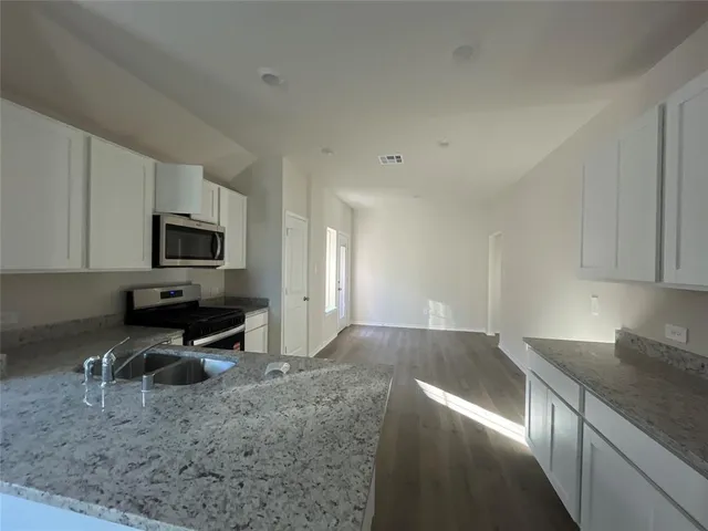 a kitchen with a sink and a stove top oven