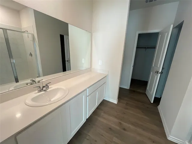 a bathroom with a double vanity sink and a mirror