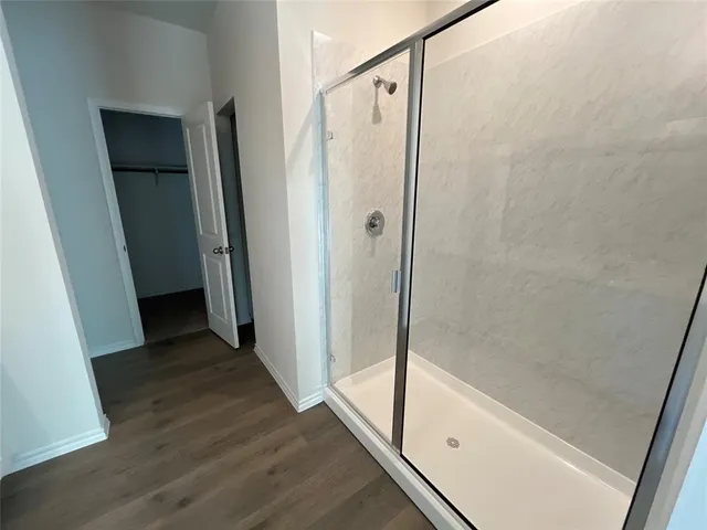 a bathroom with a glass door shower