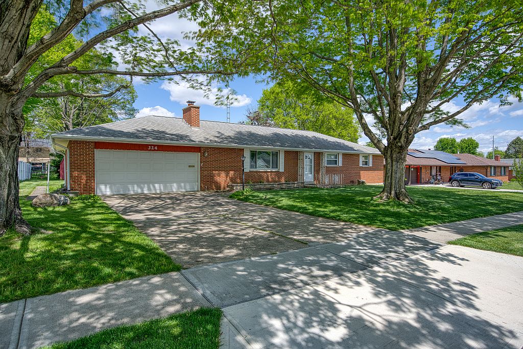 324 Beckenham Road Englewood, OH 45322 - Photo 3 of 26 This classic brick residence offers a spacious front yard and convenient attached garage.