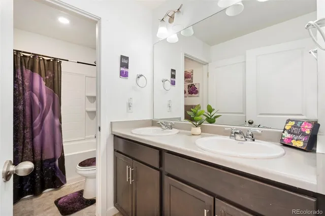 a bathroom with a sink vanity tub and a mirror