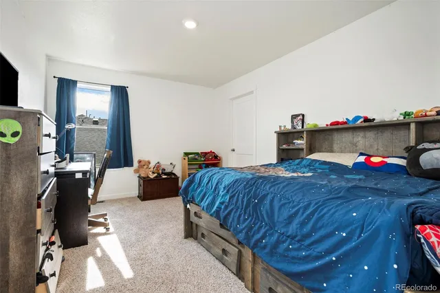 a bedroom with bed and a couch