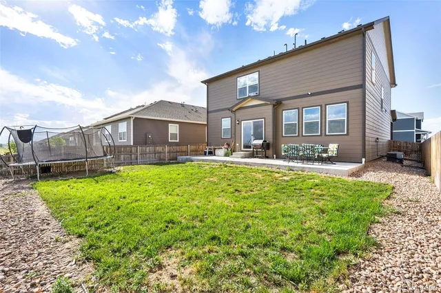 a front view of a house with a yard table and chairs