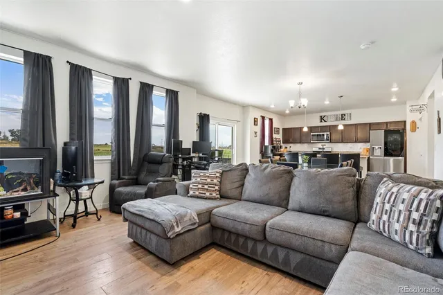 a view of living room kitchen with furniture and large window