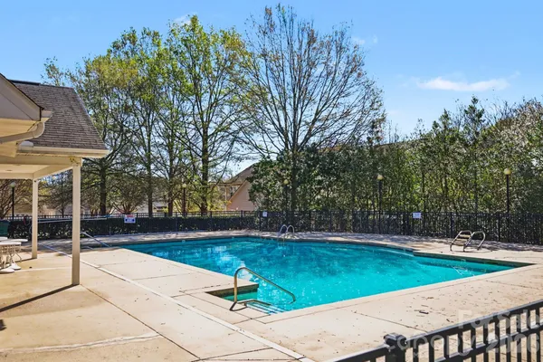 a view of a backyard with large trees