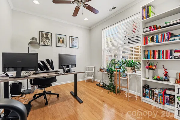 a view of a workspace with furniture bookshelf and a window