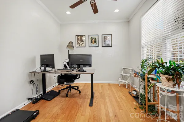 a view of a workspace with furniture and a window