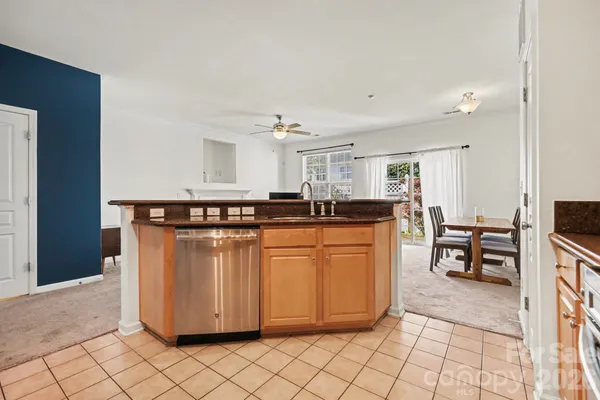 a kitchen with stainless steel appliances granite countertop a sink and cabinets